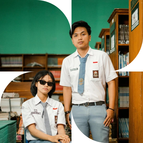 A boy student standing and a girl student wearing sunglasses and sitting on a chair